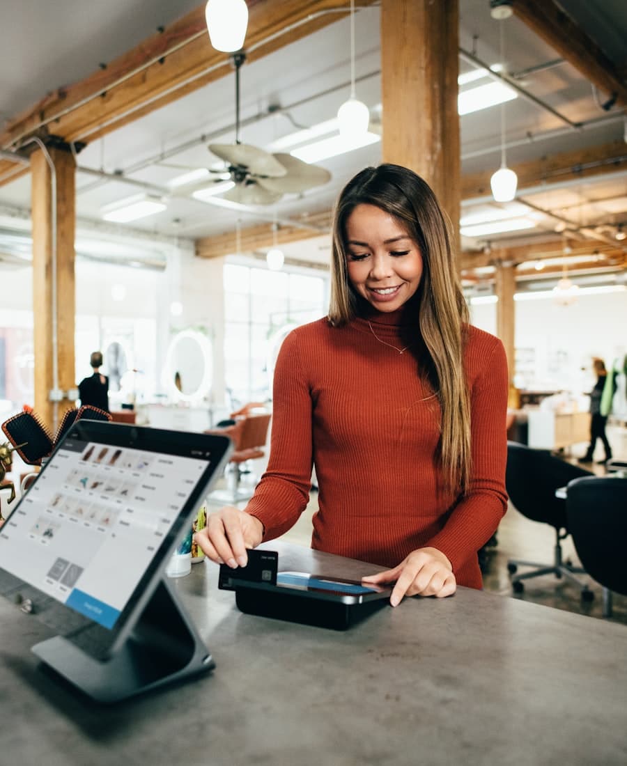 A customer paying at a point-of-sale terminal in a small business